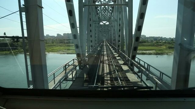 train rides on the bridge over the river
