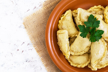 Delicious dumplings with cabbage on white background. Top view
