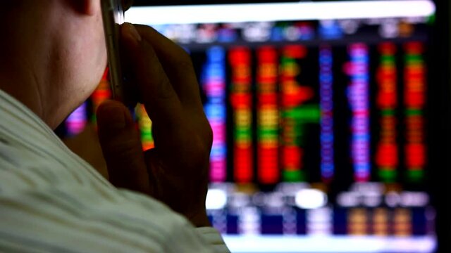 stock broker or stock trader  monitoring stocks price and calling 
