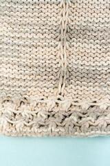 Sweater or scarf fabric texture large knitting. Knitted jersey background with a relief pattern. Braids in knitting . Wool hand- machine