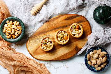 Fototapeta premium Assorted nuts with honey topping