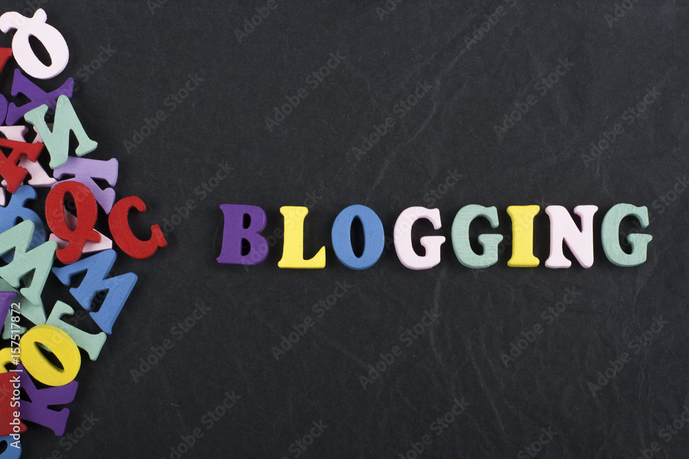 Fototapete blogging word on black board background composed from colorful abc alphabet block wooden letters, co
