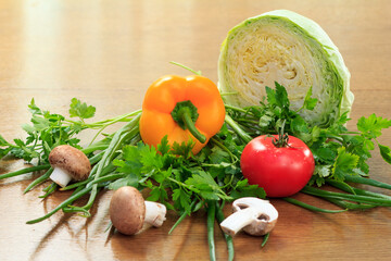Set of fresh natural products with cabbage, pepper, tomato, mushrooms, onion and parsley