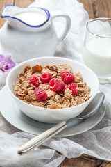 Tasty breakfast with milk and raspberries.