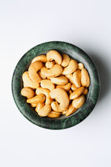 Roasted cashew nuts in a marble bowl