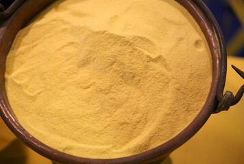Yellow wheat flour in the old copper pail