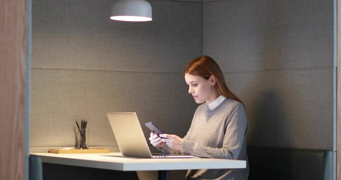 Businesswoman working late at night in office alone