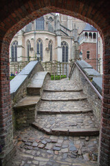 Fototapeta na wymiar Stone stairway to the Grand Gothic style church in Bruges (Brugge), Belgium