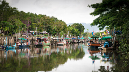 Fototapeta na wymiar Tilt-shift blur effect. Fishing boats in canal.
