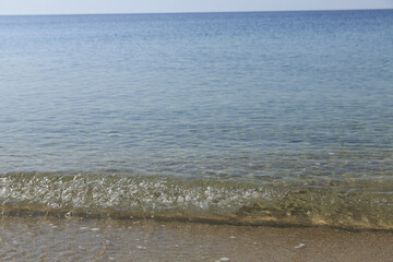 Soft sea wave on sandy beach, Beautiful Greek beach with fine sand, Close up photo of sandy beach with soft wave in motion