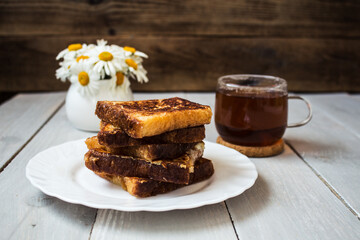 french toast with tea on wooden background