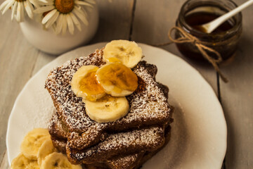 french toast with bannana on wooden background