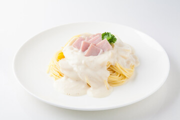 Spaghetti Carbonara with sauce on white plate