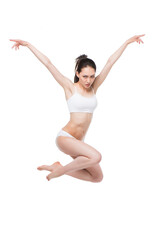 Fototapeta premium asian woman in lingerie jumping with arms up isolated on white
