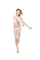 cheerful asian woman in lingerie jumping isolated on white