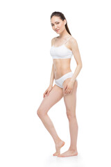 Fototapeta premium Sensual young asian woman posing in white lingerie and smiling at camera