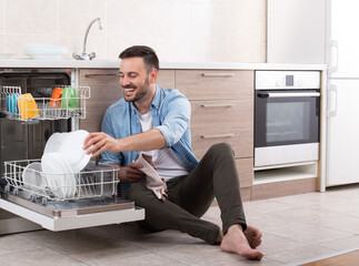 Man unloading dishwasher