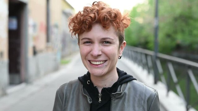 Portrait of young woman looking camera outdoor &ndash; serene, carefree, pensive concept