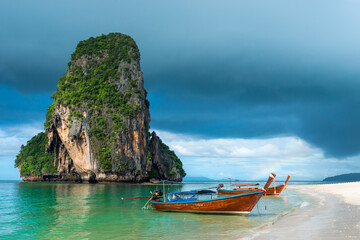 Fototapeta na wymiar Small traditional Thai boats off the coast of Phra Nang, Thailand
