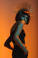 young fashionable african american girl posing in headpiece with needles