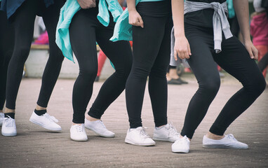 Group of teenage girls dancing on the street.