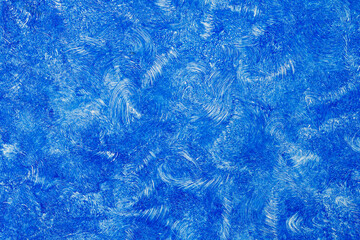 Artistic drawing of a blue paint on a white wall. Abstract background.