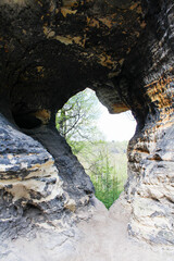 Rock mountain in Tisa, cave with opening shaped to heart. Czech landscape