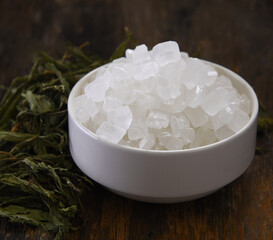 Rock sugar in white bowl and Stevia dry on table