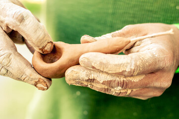 The hands of the master make a ceramic pip