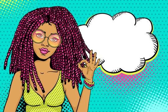 Pop art female face. Sexy african american hippie woman with pink dreadlocks in round glasses shows okay sign and empty speech bubble. Vector colorful background in pop art retro comic style.
