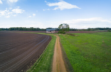 Dirt Road leading to an old abandoned farm house 