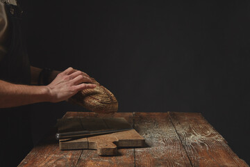 Hands holding round bread