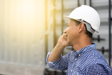 Construction worker talking on the phone at a building site