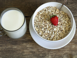 Oatmeal milk strawberry blueberry old board background