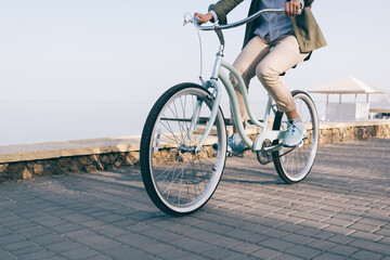 woman is riding a beautiful bicycle along the sea