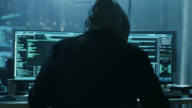 Dangerous Hooded Hacker Breaks into Government Data Servers and Infects Their System with a Virus. Shot on RED EPIC-W 8K Helium Cinema Camera.