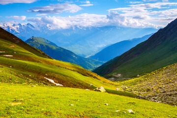 Landscape with picturesque meadows and mountains.