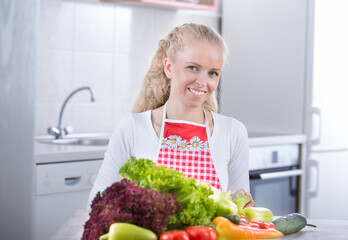 Woman with bunch of vegetables on table