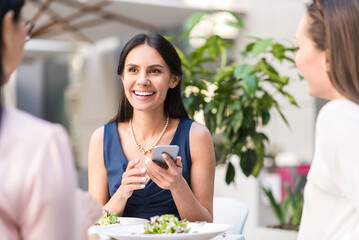 Cheerful female sending sms by mobile
