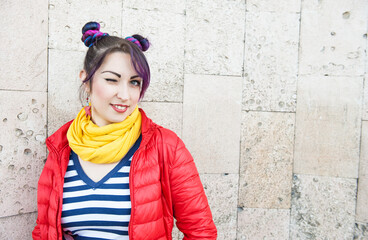 Young beautiful fashion hipster woman with colorful hair winking