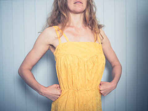 Woman posing in yellow dress