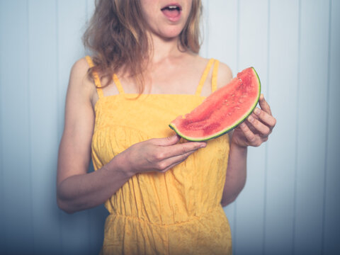Young woman eating water melon