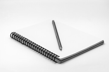Cover notebook and pencil on white background