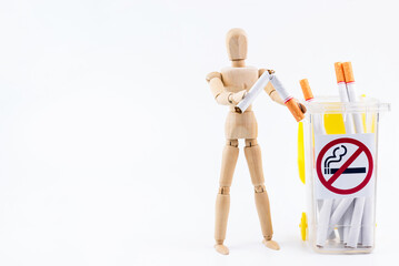Wooden puppet take the cigarettes to dumps.No Smoking Day background.Anti smoking.