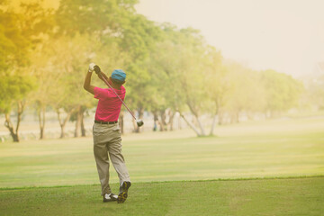 Asian golfers hit sweeping and keep golf course in the summer for relax time,soft focus and blurry