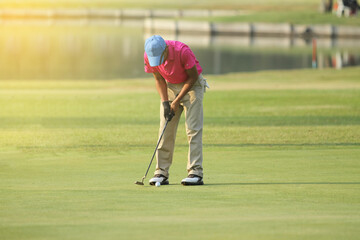 Asian golfers hit sweeping and keep golf course in the summer for relax time,soft focus and blurry