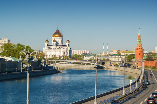 Morning view of Bolshoy Kamenny Bridge over Moskva River, embankments, Kremlin Towers, Cathedral of Christ the Saviour in Moscow, Russia.