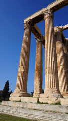 Photo of iconic pillars of Temple of Olympian Zeus with view to the Acropolis and the Parthenon, Athens historic center, Attica, Greece 