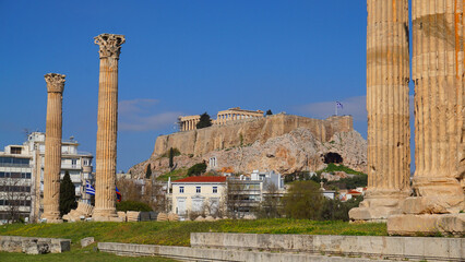 Photo of iconic pillars of Temple of Olympian Zeus with view to the Acropolis and the Parthenon,...