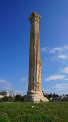 Fototapeta na wymiar Photo of iconic pillars of Temple of Olympian Zeus with view to the Acropolis and the Parthenon, Athens historic center, Attica, Greece 